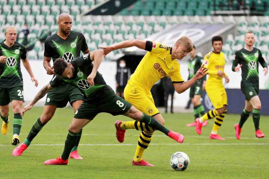 Borussia Dortmund's Erling Haaland in action with VfL Wolfsburg's Renato Steffen, as play resumes behind closed doors following the outbreak of COVID-19.  (REUTERS)
